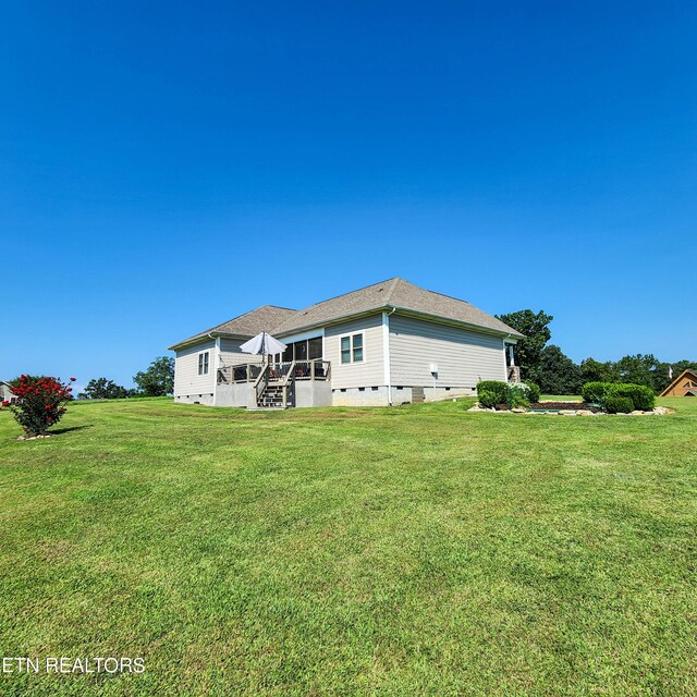 back of property featuring a patio area and a lawn