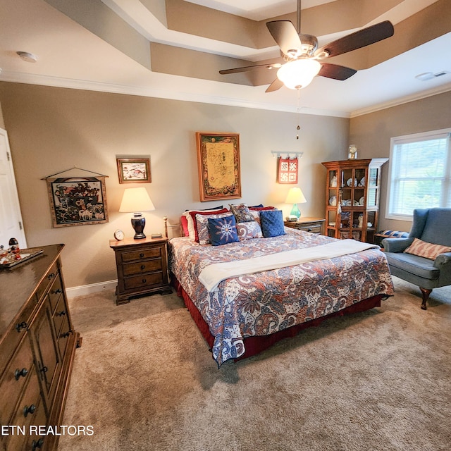 carpeted bedroom with ceiling fan and ornamental molding