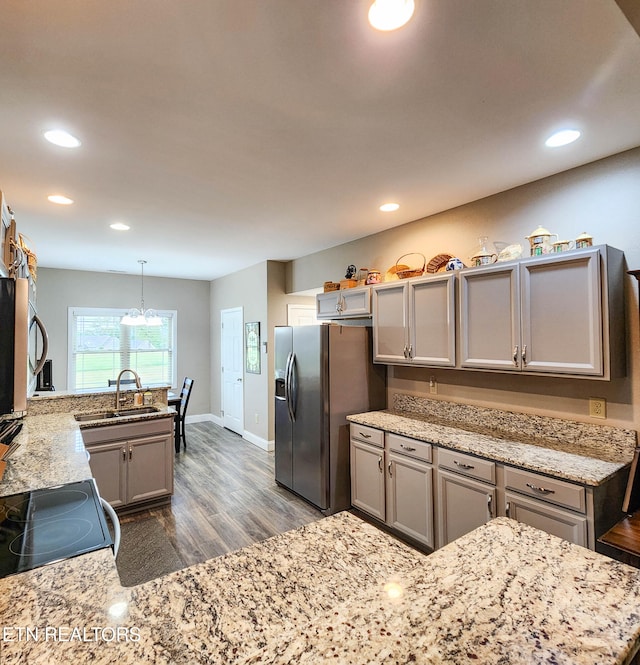 kitchen with hanging light fixtures, stainless steel refrigerator with ice dispenser, sink, gray cabinets, and dark hardwood / wood-style flooring