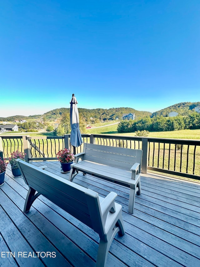 wooden deck with a mountain view