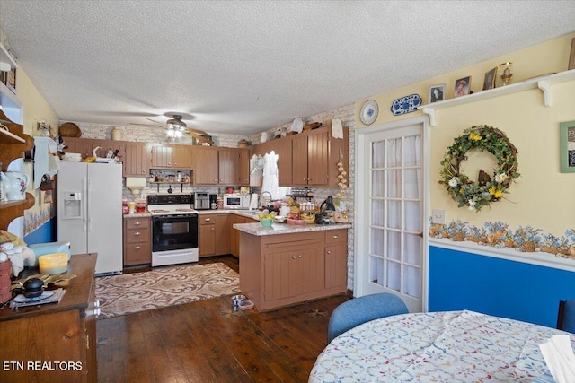 kitchen featuring brown cabinets, white appliances, light countertops, and dark wood finished floors