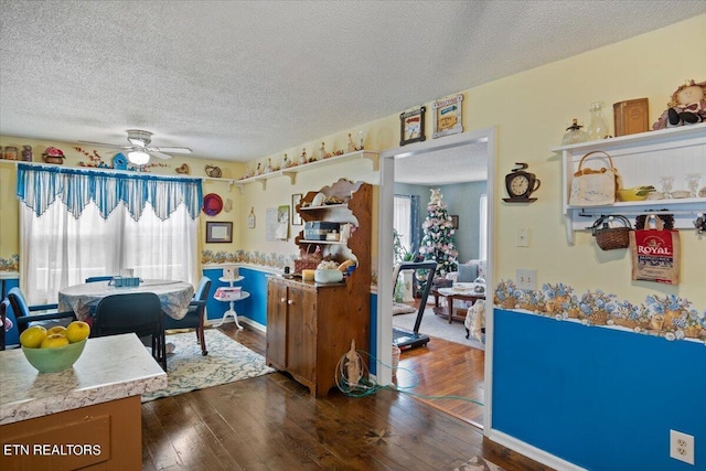 kitchen featuring a textured ceiling, ceiling fan, dark wood-type flooring, light countertops, and open shelves