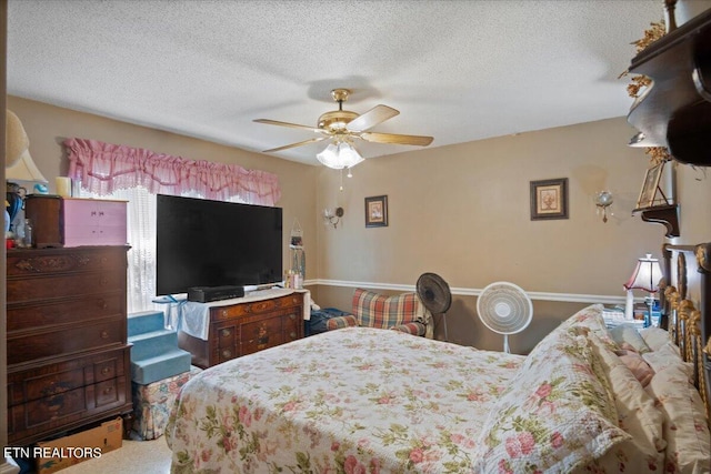 bedroom featuring a textured ceiling, ceiling fan, and baseboards