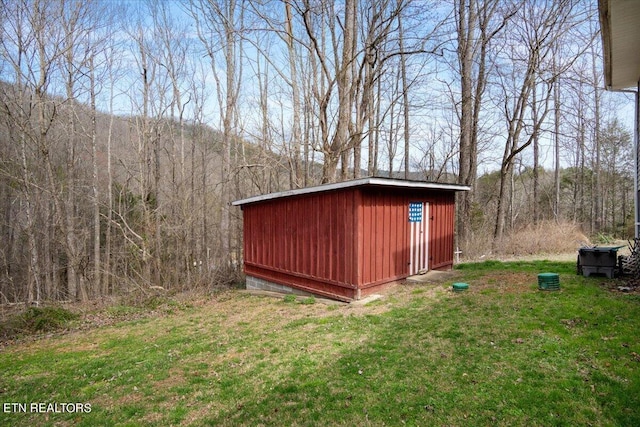 view of shed featuring a forest view