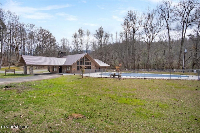 surrounding community featuring a yard, fence, driveway, and a swimming pool