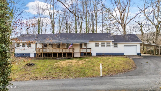 ranch-style home featuring aphalt driveway, crawl space, a wooden deck, a carport, and a front yard