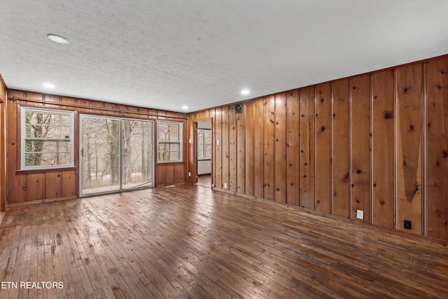 spare room featuring a textured ceiling, hardwood / wood-style floors, and recessed lighting