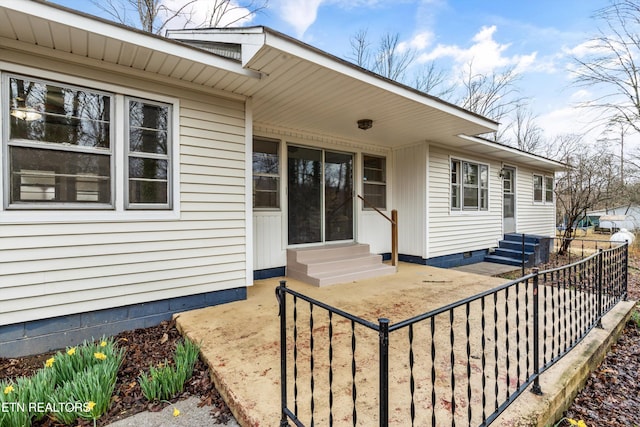 exterior space featuring entry steps and fence