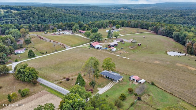 birds eye view of property with a rural view and a wooded view