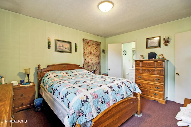 bedroom featuring dark colored carpet