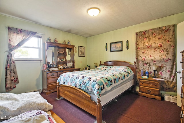 bedroom featuring a textured ceiling and carpet flooring