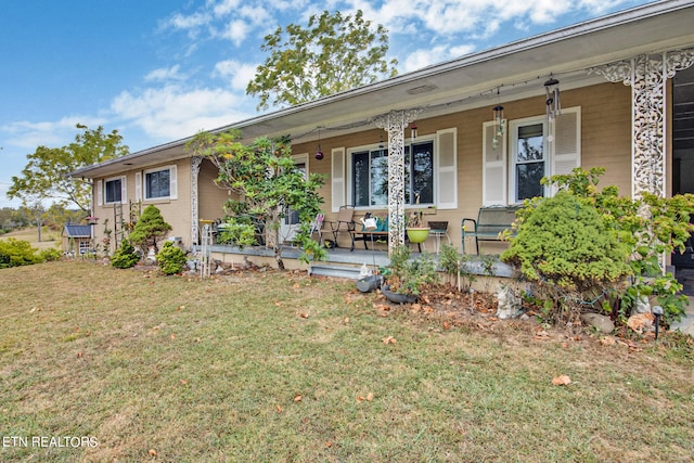 single story home with covered porch and a front yard