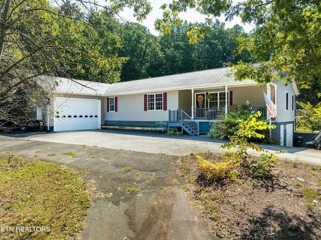 single story home with a garage and a porch