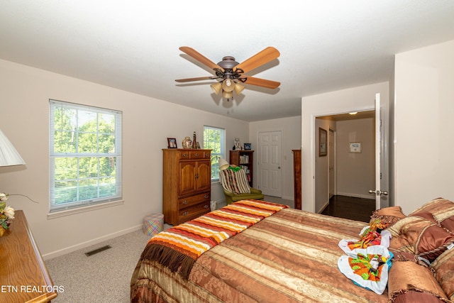 bedroom featuring ceiling fan and carpet