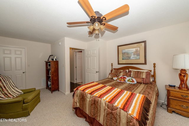 bedroom with light carpet and ceiling fan