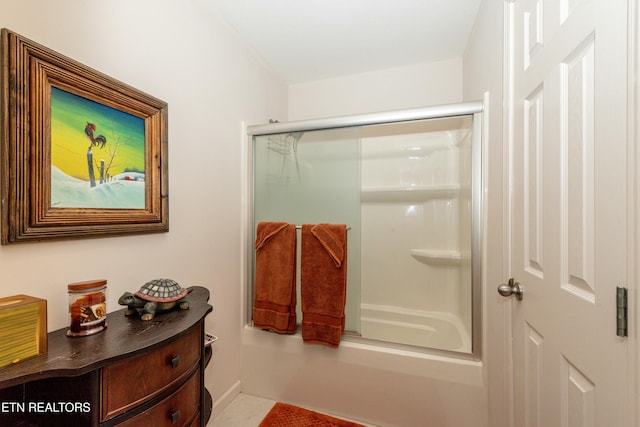 bathroom with combined bath / shower with glass door