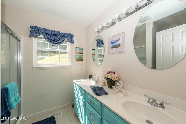 bathroom with vanity, a shower with door, and tile patterned flooring