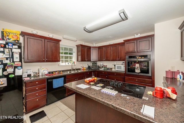 kitchen with black appliances, dark stone counters, sink, and light tile patterned floors