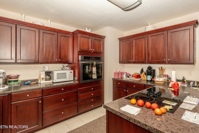 kitchen featuring oven and light tile patterned floors