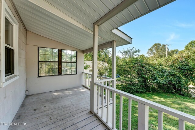 wooden deck featuring a yard