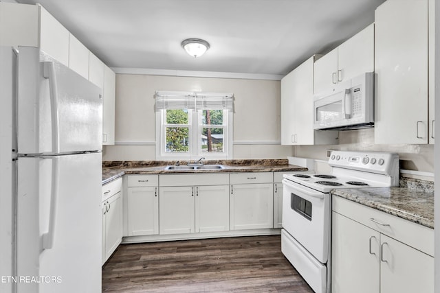 kitchen featuring white appliances, white cabinetry, and a sink