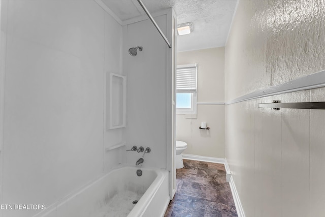 full bathroom featuring  shower combination, baseboards, a textured ceiling, and toilet