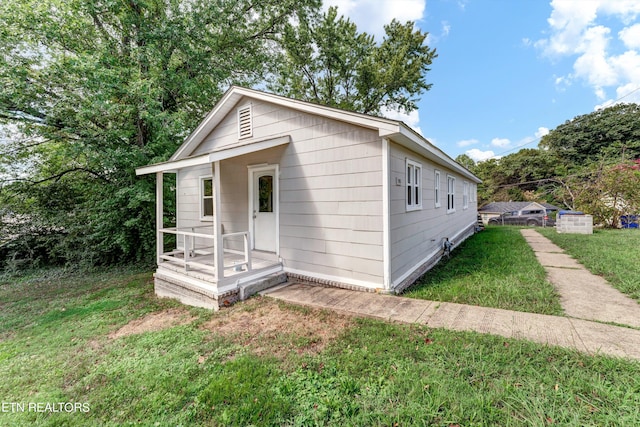 bungalow-style home with a front yard