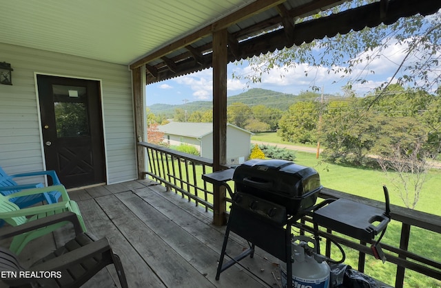 deck with grilling area and a yard