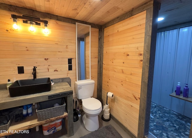 bathroom with wood walls, toilet, wooden ceiling, and sink