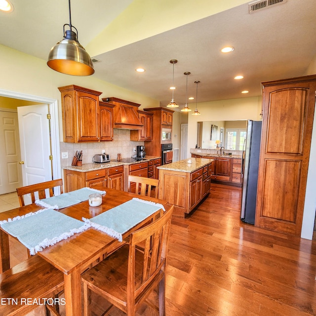 dining room featuring sink and hardwood / wood-style flooring