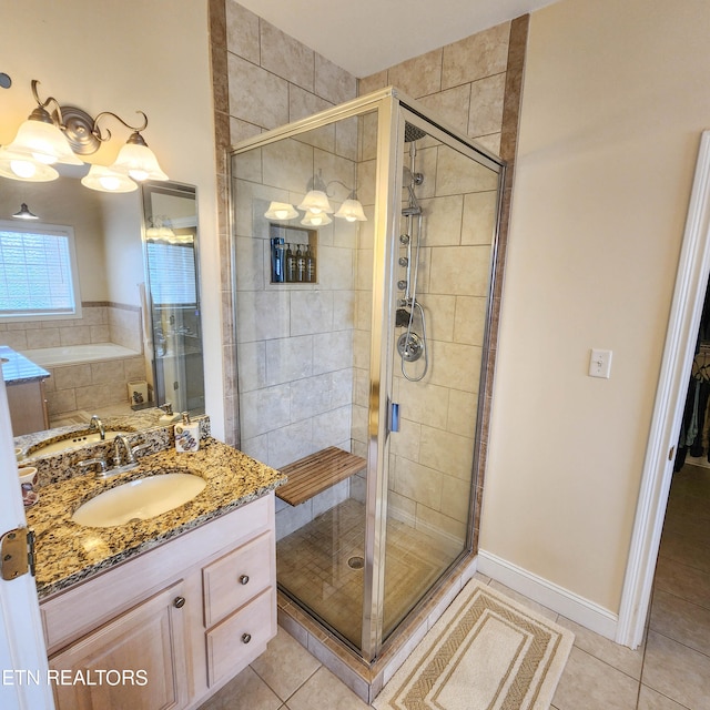 bathroom featuring tile patterned floors, an enclosed shower, and vanity