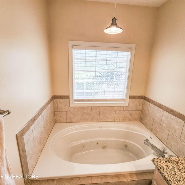 bathroom featuring vanity and a relaxing tiled tub