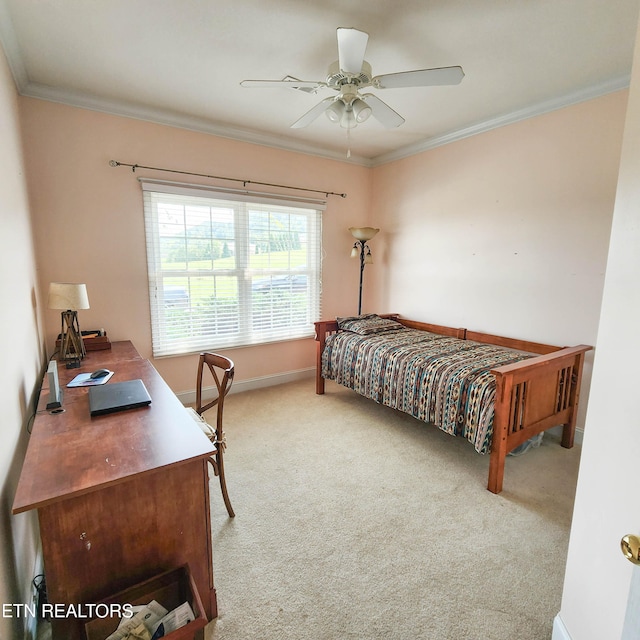 carpeted bedroom featuring ceiling fan and ornamental molding