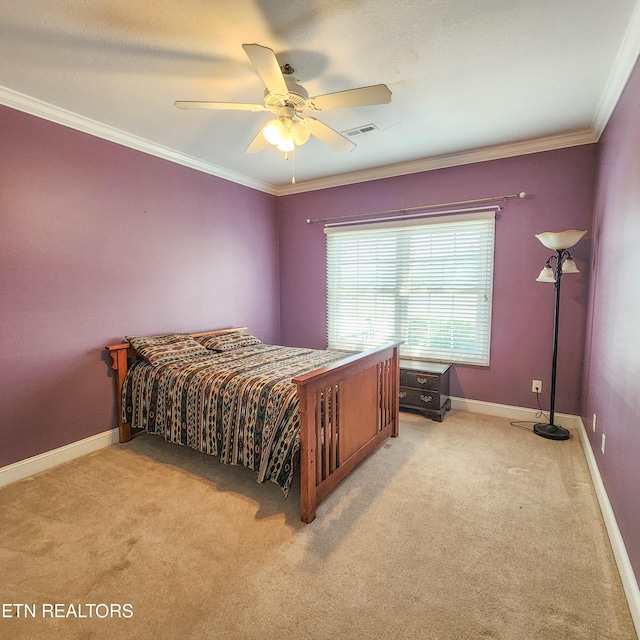 carpeted bedroom featuring ceiling fan and crown molding