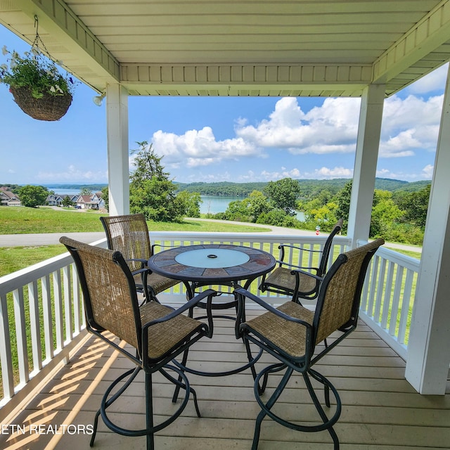 wooden terrace featuring a water view