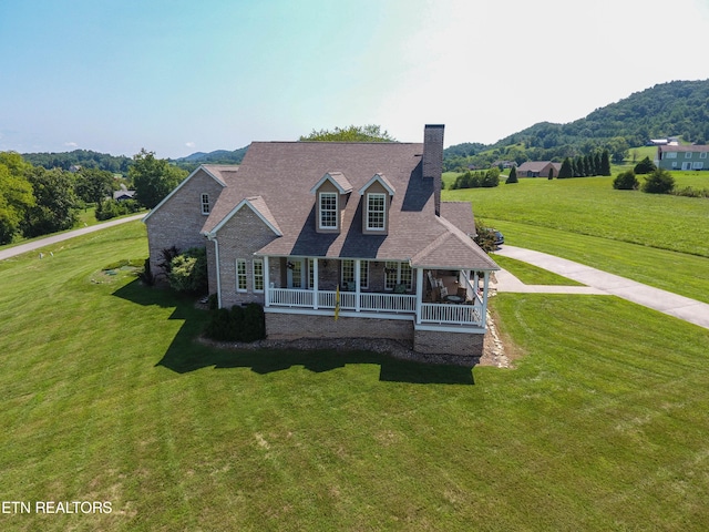 view of front of home featuring a porch and a front yard