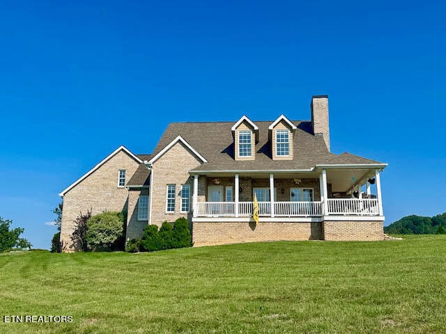 view of front of home with covered porch and a front yard