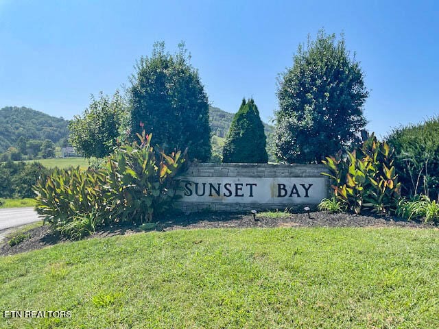 community / neighborhood sign with a lawn