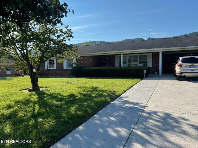 ranch-style house featuring a front lawn and a garage