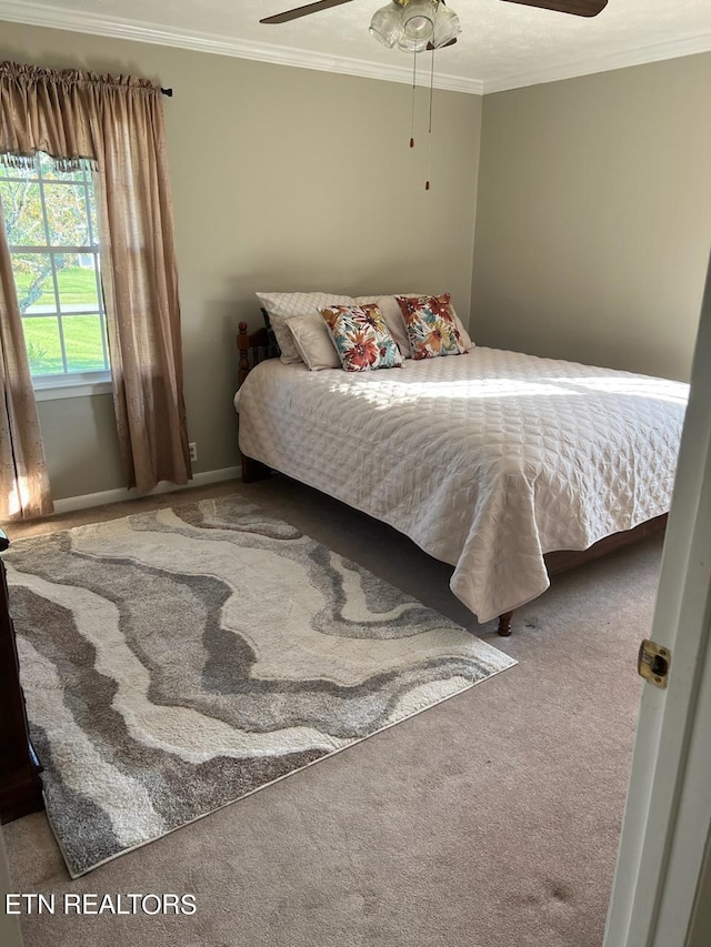 bedroom with ceiling fan, carpet floors, and crown molding