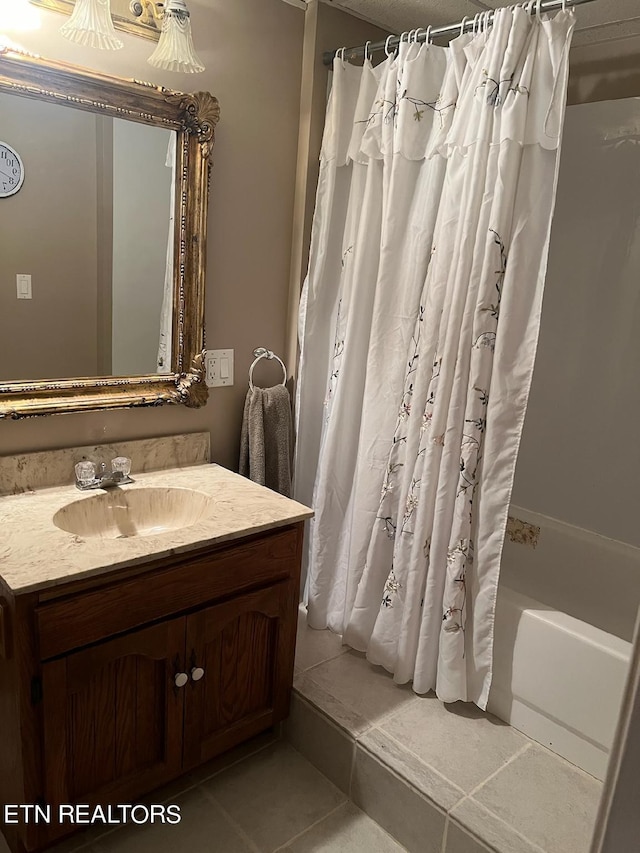 bathroom with tile patterned flooring, shower / bathtub combination with curtain, and vanity