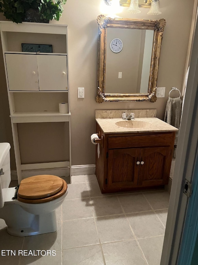 bathroom with vanity, tile patterned flooring, and toilet