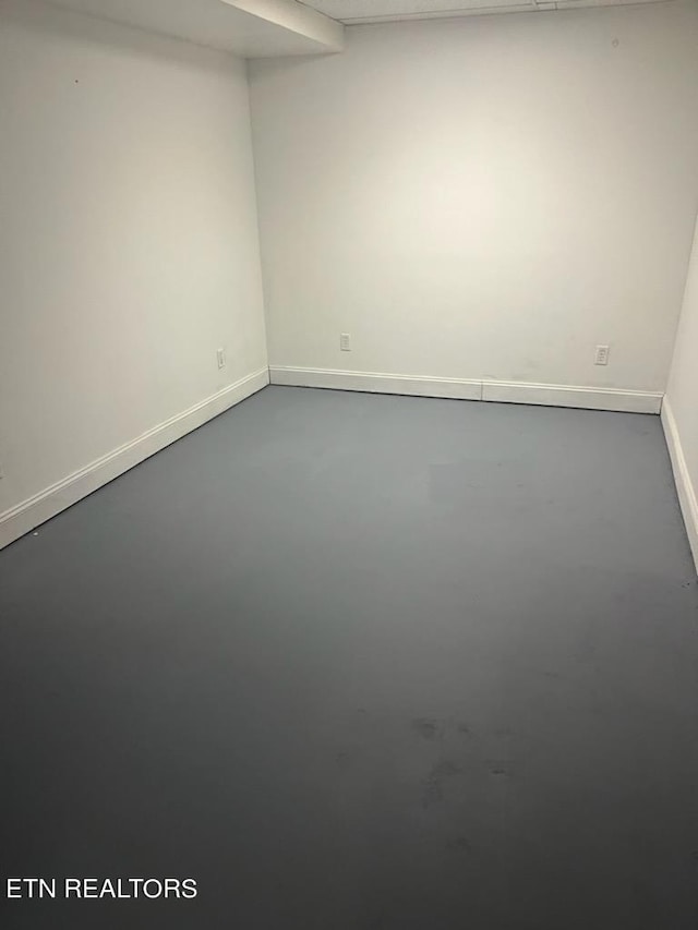 unfurnished room with concrete floors