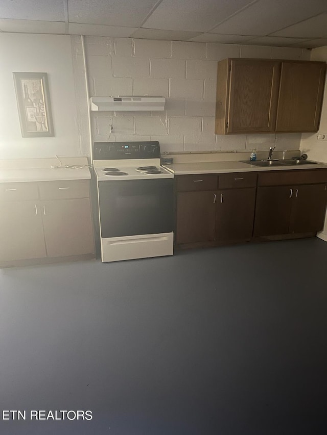 kitchen featuring a drop ceiling, white electric range oven, sink, and dark brown cabinets