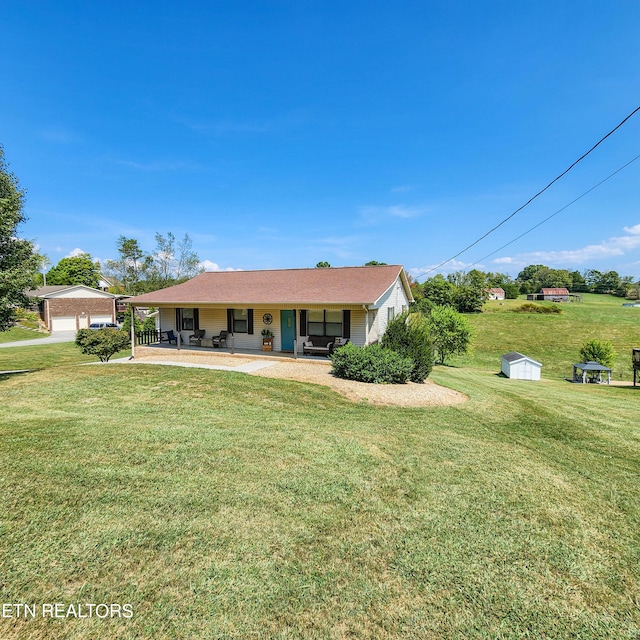 ranch-style home featuring a front lawn and a garage