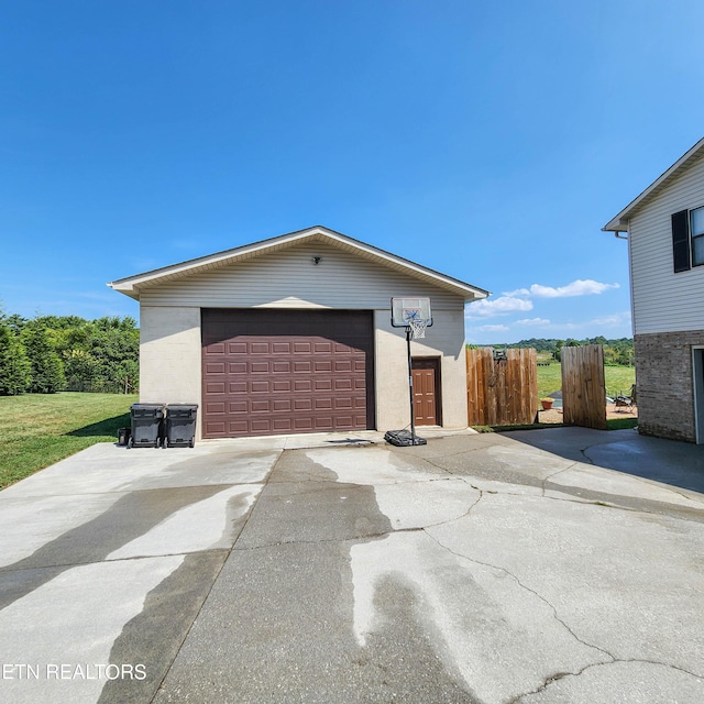 detached garage featuring fence