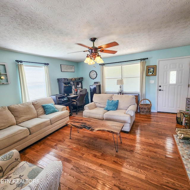 living area featuring ceiling fan, a textured ceiling, and hardwood / wood-style floors