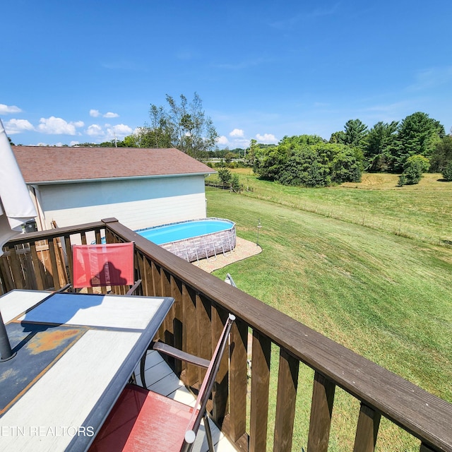 wooden terrace featuring a lawn