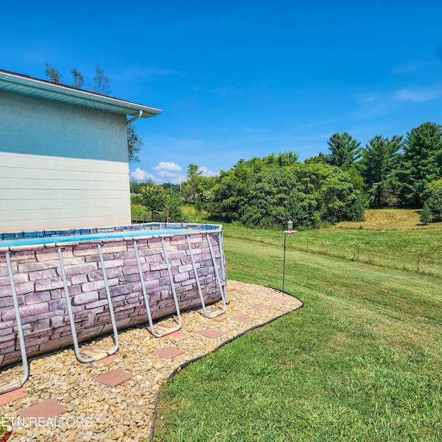 view of yard with an outdoor pool