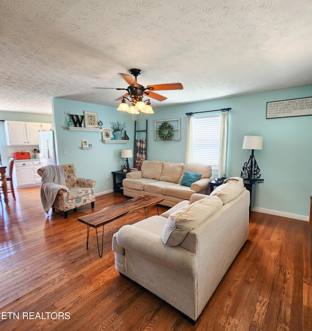 652 Noes Chapel Rd, Morristown, TN 37814 - living area featuring a textured ceiling, a ceiling fan, hardwood / wood-style flooring, and baseboards